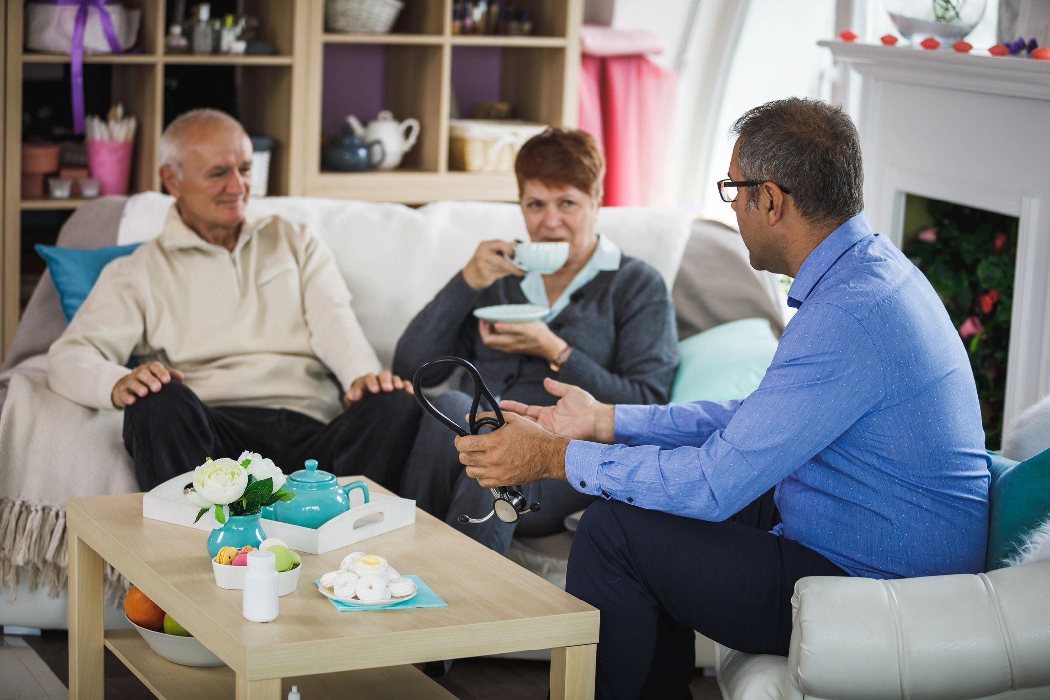 Elderly couple listening to a doctor during an in-home consultation