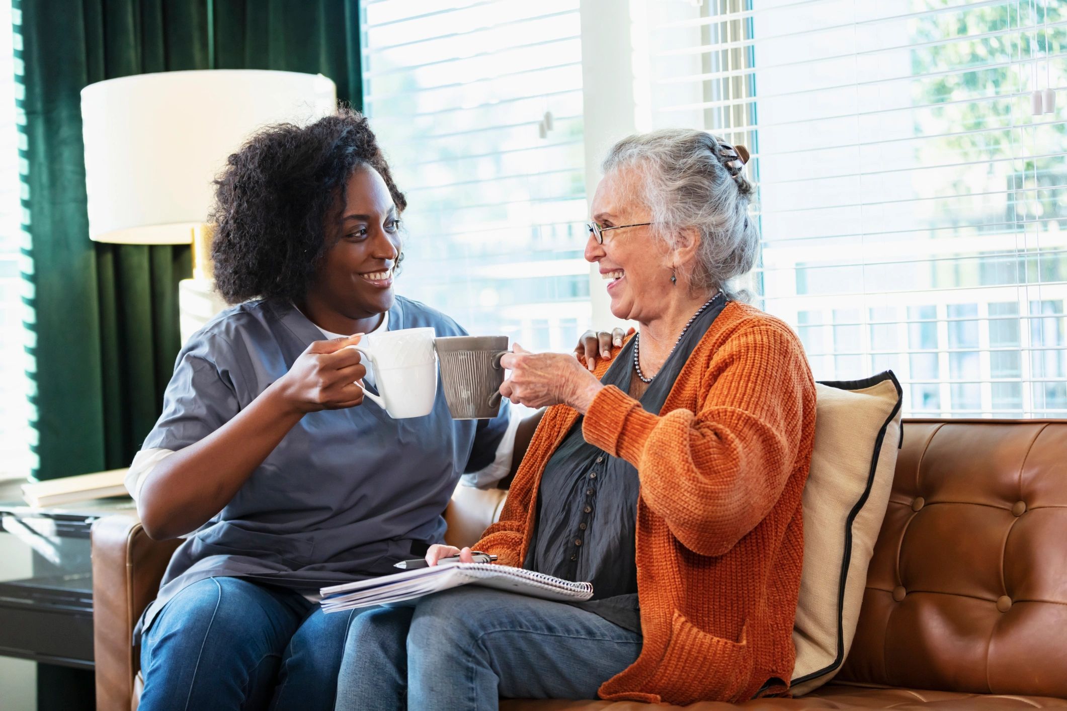 Senior woman talking with a caregiver at home