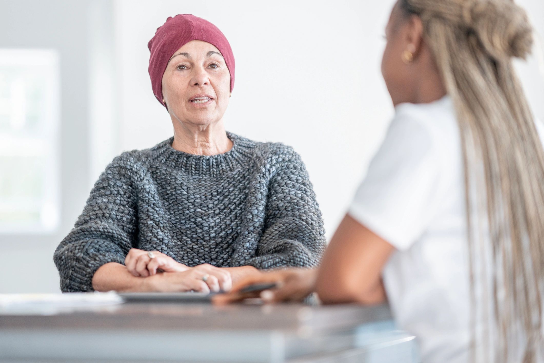 Care consultation between an older woman and a healthcare professional