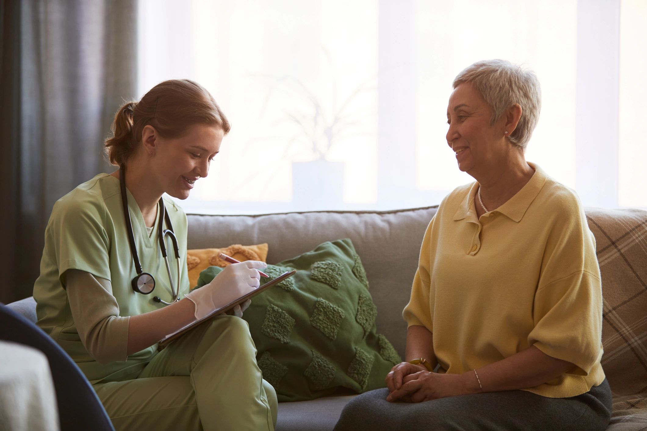 Senior woman meeting with a care professional to discuss support options
